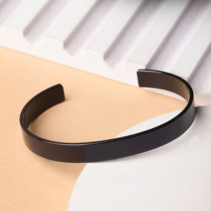Black-plated stainless steel kada bracelet by Wukusy, stylish fashion accessory featuring a sleek, polished design.