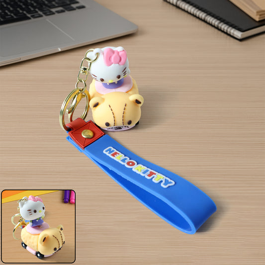 Silicone keychain featuring a cute cartoon cat riding a toy car, designed by Wukusy, with colorful and playful details.
