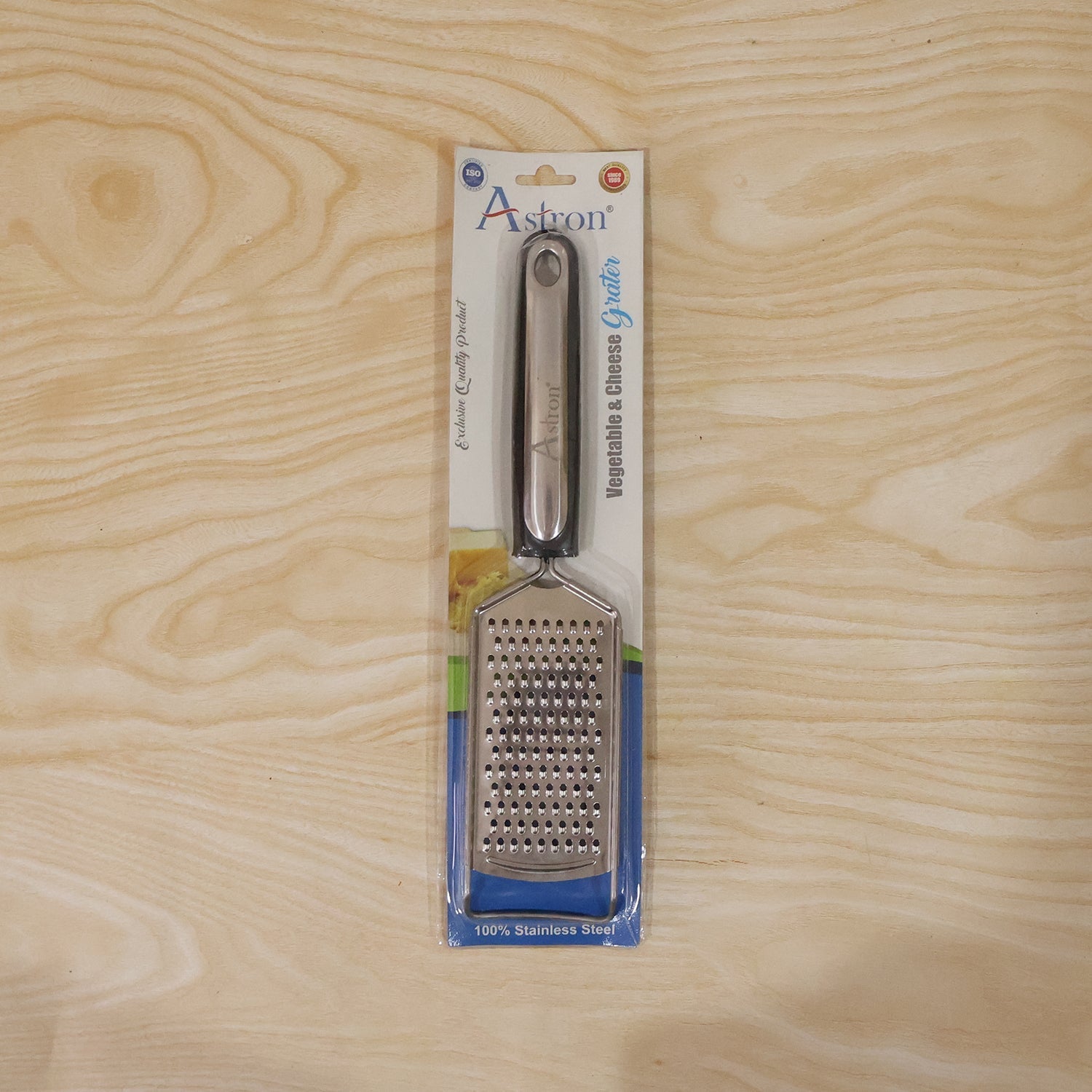 Wukusy SS slim cheese grater with plastic handle for vegetables and lemon zest, shown with grated produce on a clean surface.