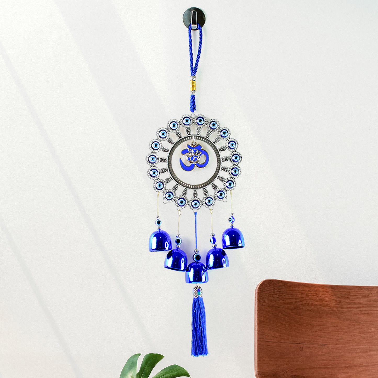 Decorative Om Evil Eye wind chime wall hanging by Wukusy featuring colorful glass beads and metal accents, hanging against a neutral background.