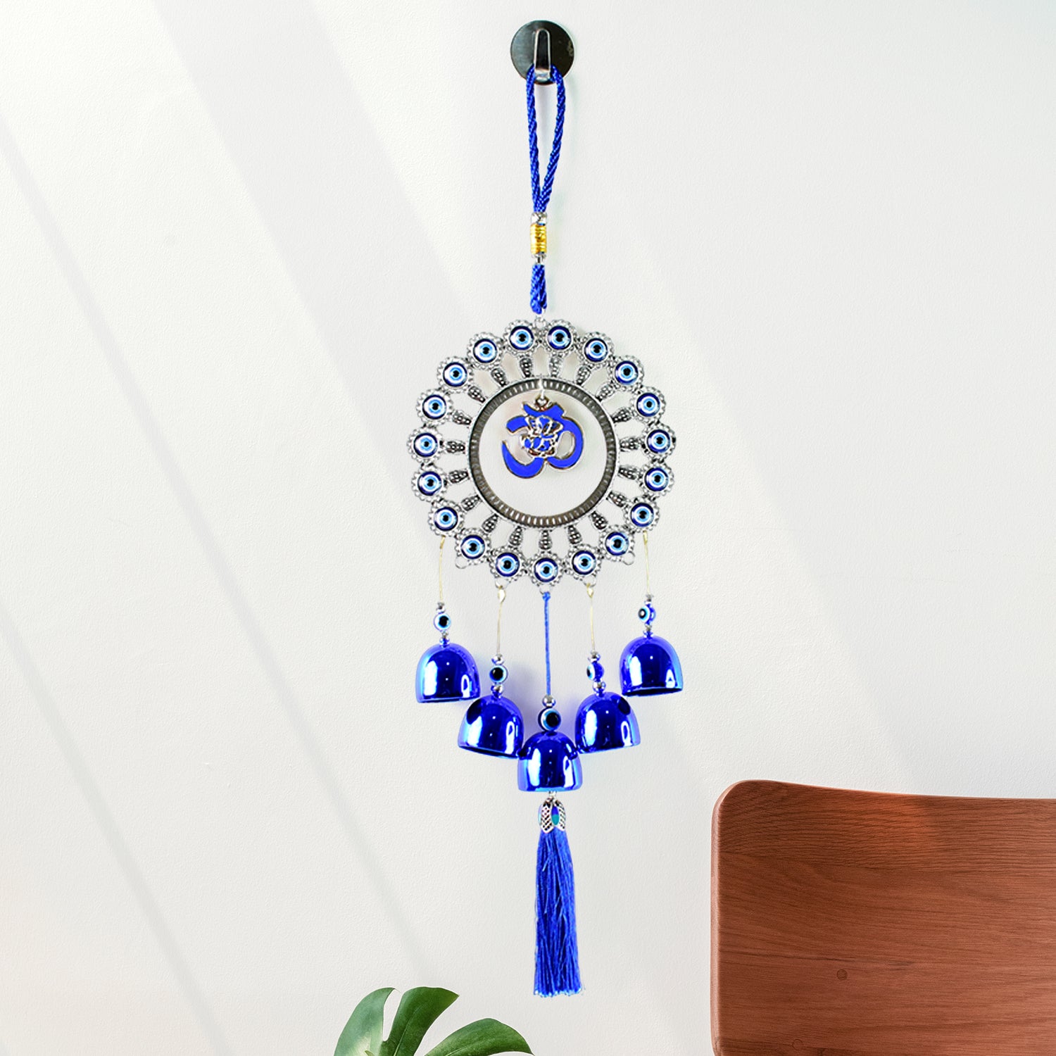 Decorative Om Evil Eye wind chime wall hanging by Wukusy featuring colorful glass beads and metal accents, hanging against a neutral background.