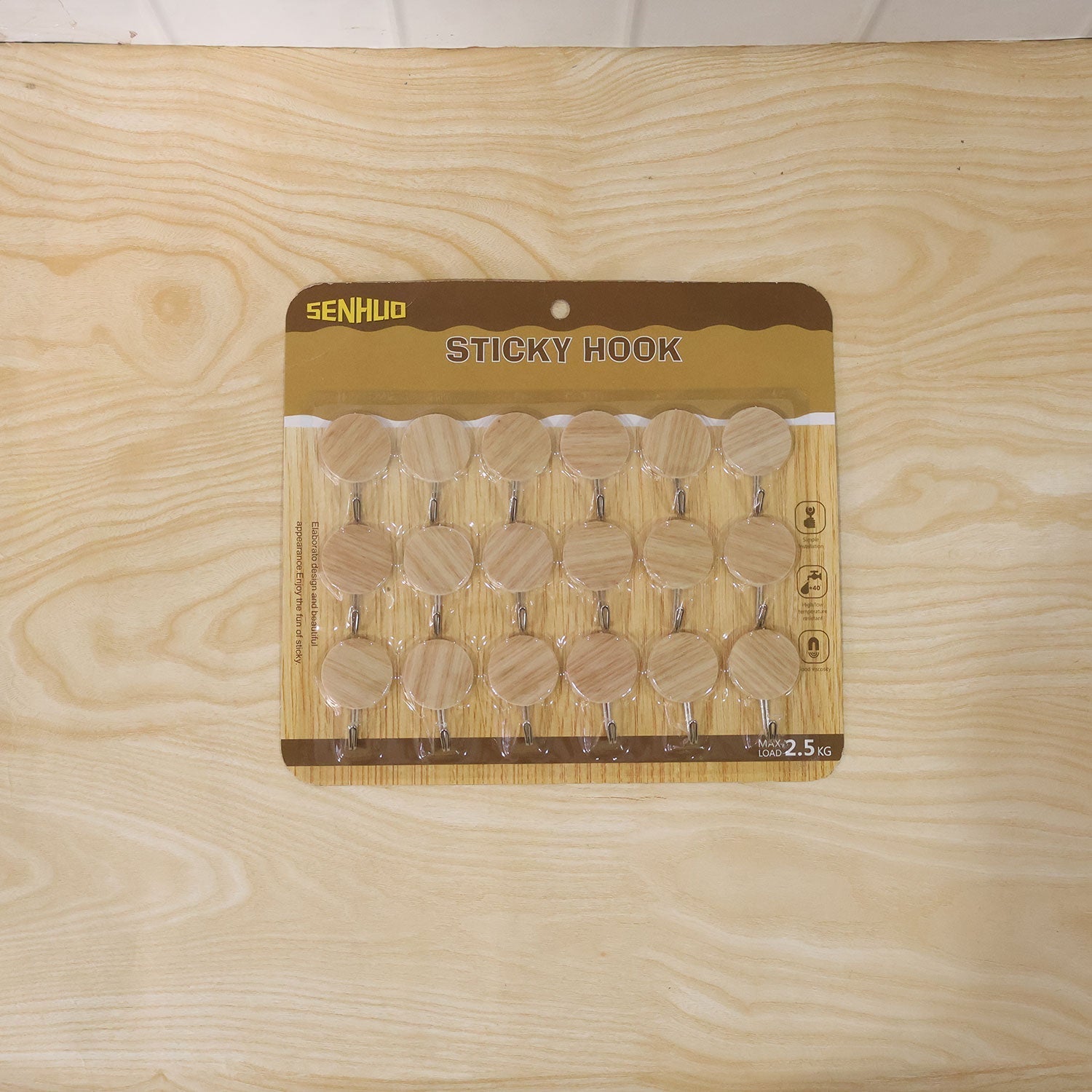 Wukusy self-adhesive wooden look wall hooks, strong sticky hangers without drilling, shown attached to a wall in a set of 18 pieces.