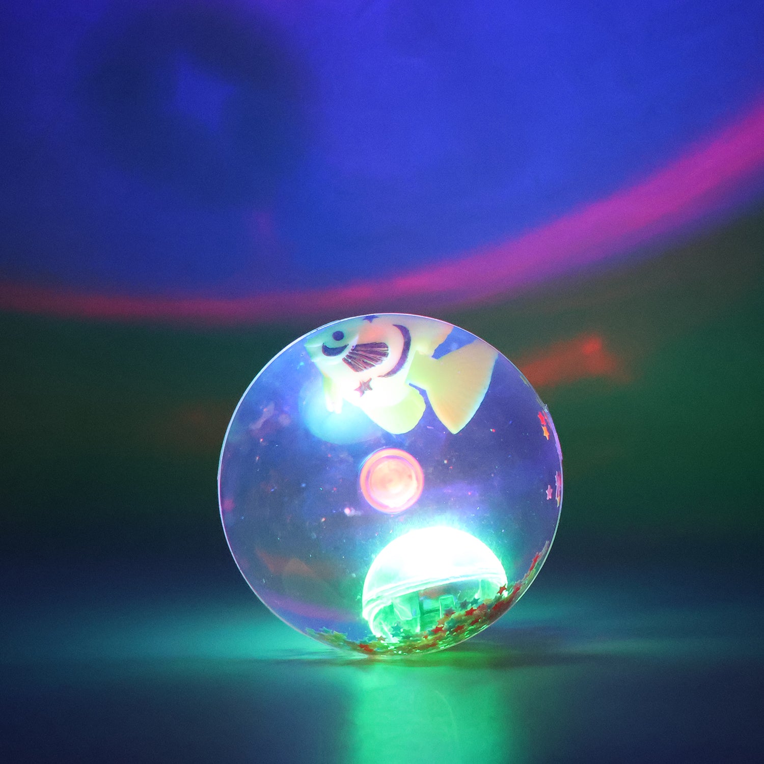 Light-up bouncy fish toy by Wukusy with impact-activated LED flashing, sensory toy for children, featuring a colorful fish design.
