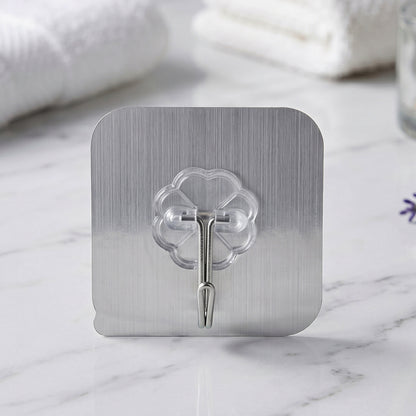 Transparent heavy-duty self-adhesive wall hook by Wukusy, showing a close-up of the clear hook attached to a wall surface.