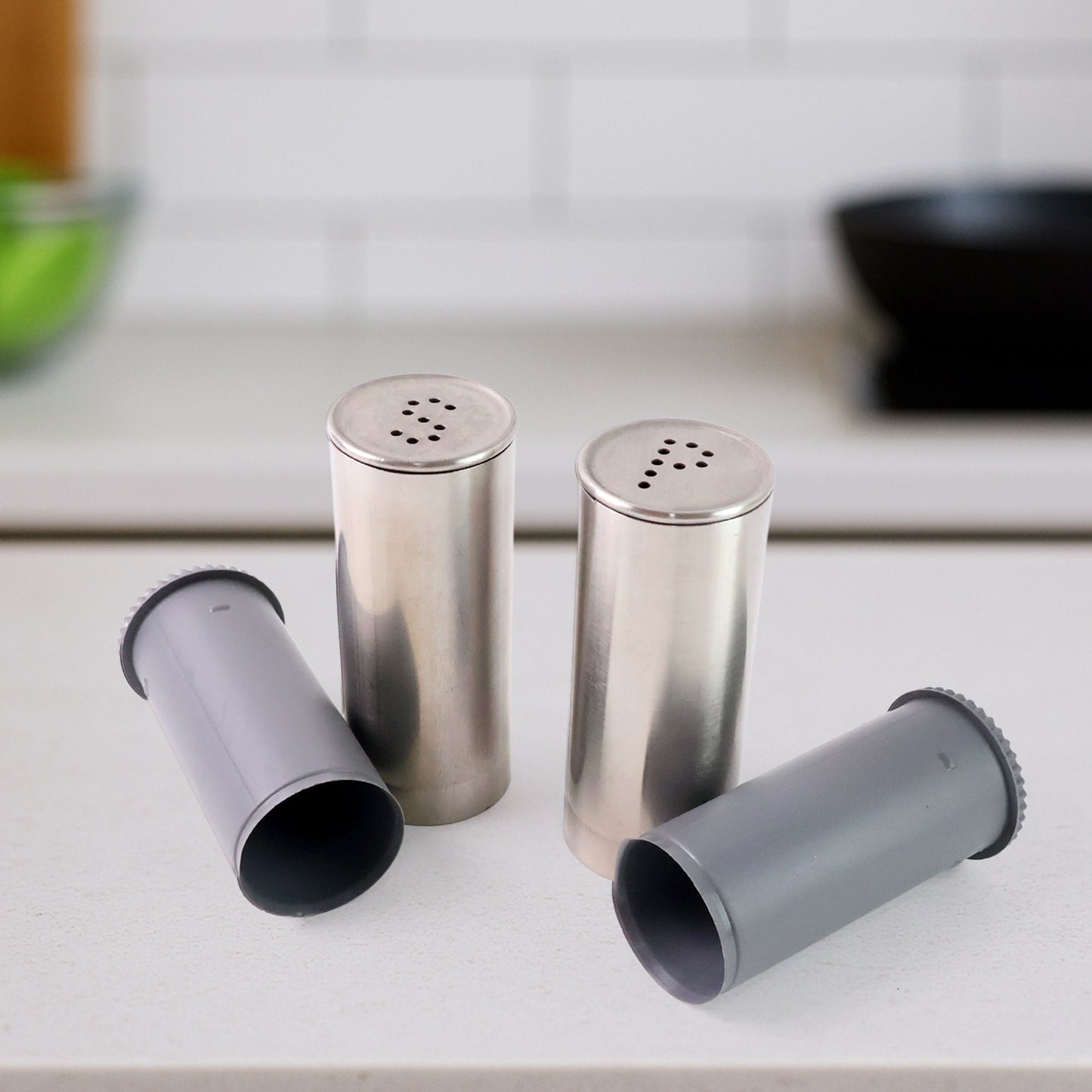 Wukusy stainless steel salt and pepper shaker set with sleek, modern design and clear tops for easy refilling.