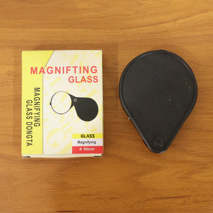 Wukusy portable handheld magnifying glass with ergonomic handle, close-up view showing clear lens for detailed inspection.