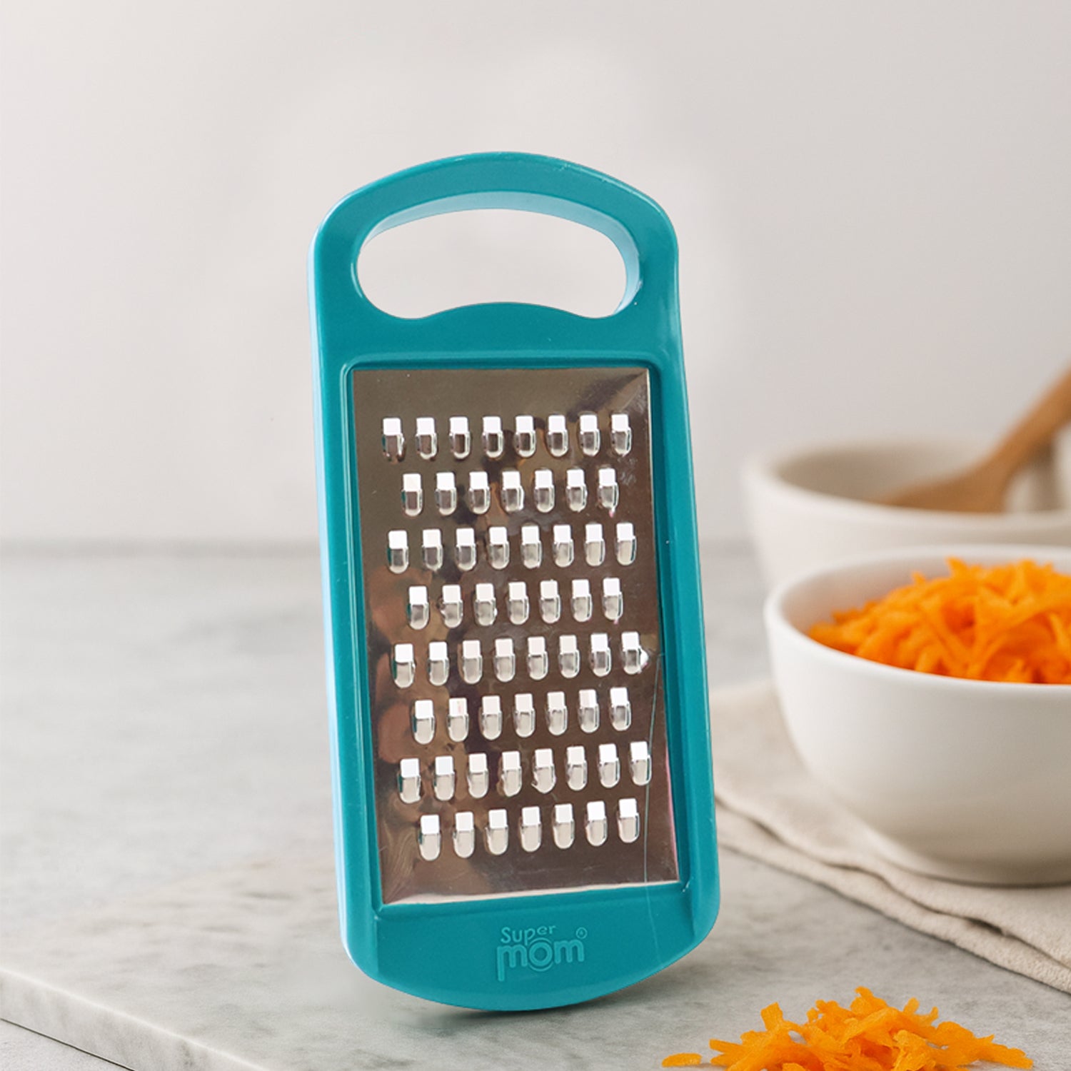 Wukusy multipurpose cheese and vegetable grater with stainless steel blades and ergonomic handle for versatile food preparation.