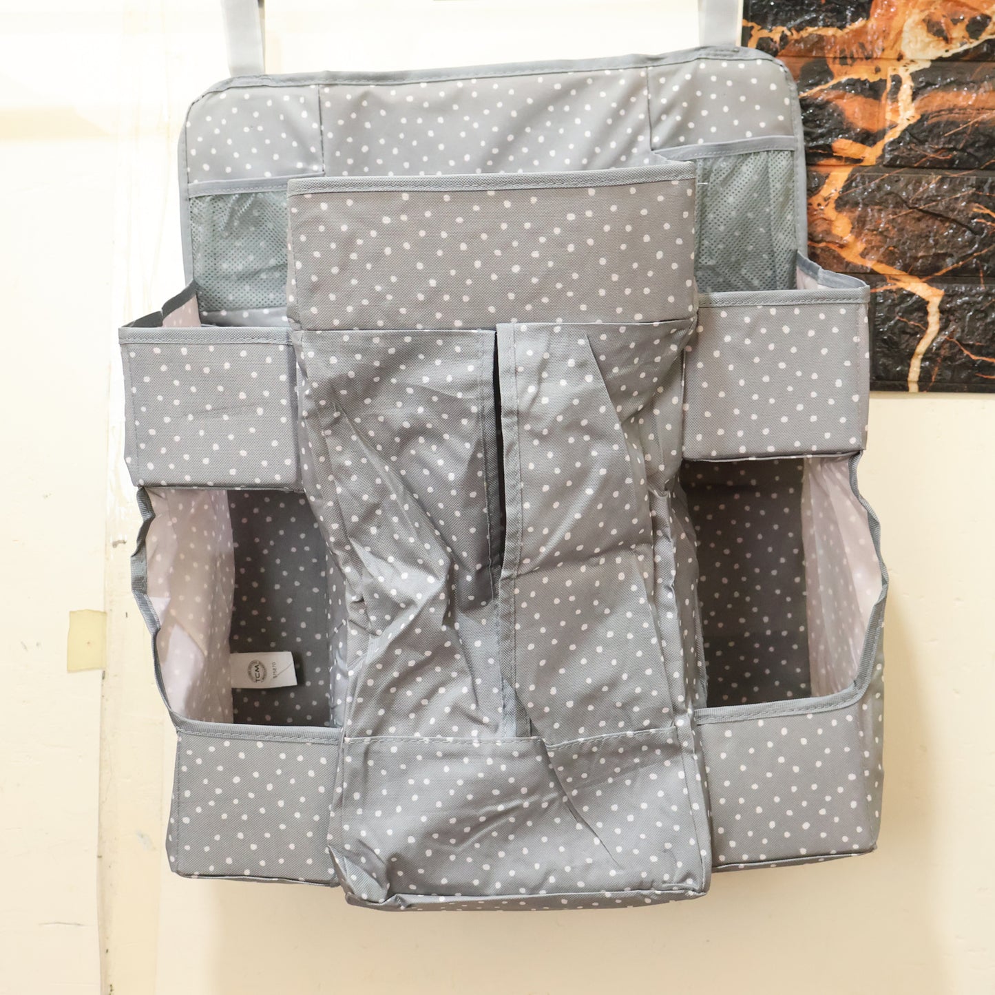 Wukusy multi-pocket hanging baby care organizer with multiple compartments for diapers, wipes, and baby essentials.