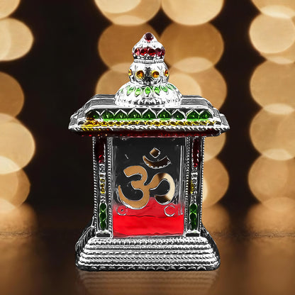 Small adhesive Om temple for car dashboard, Wukusy home improvement accessory, visible with religious symbol and mounting adhesive.