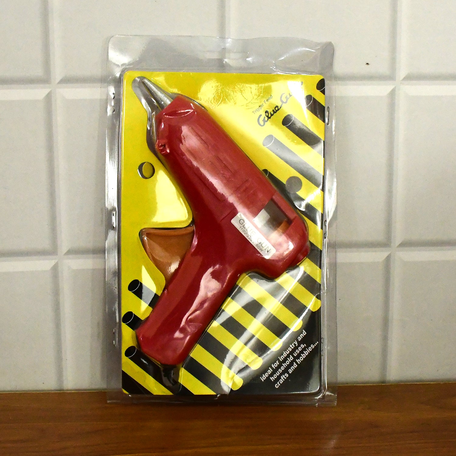 Wukusy 60W hot melt glue gun with on/off switch, suitable for office use, shown with glue sticks ready for crafting or repairs.