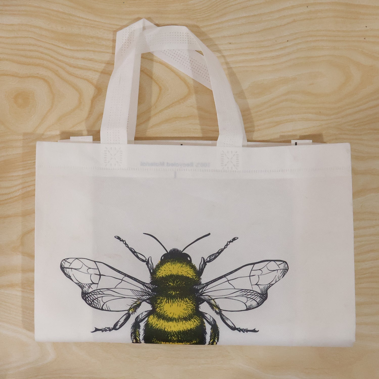 Wukusy multipurpose carry hand bag with a vibrant bee print, featuring a spacious design and sturdy handles for versatile use.