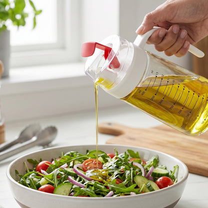 Wukusy glass oil dispenser bottle with auto-flip cap and side handle, 500ml, showing the clear glass container and flip lid.