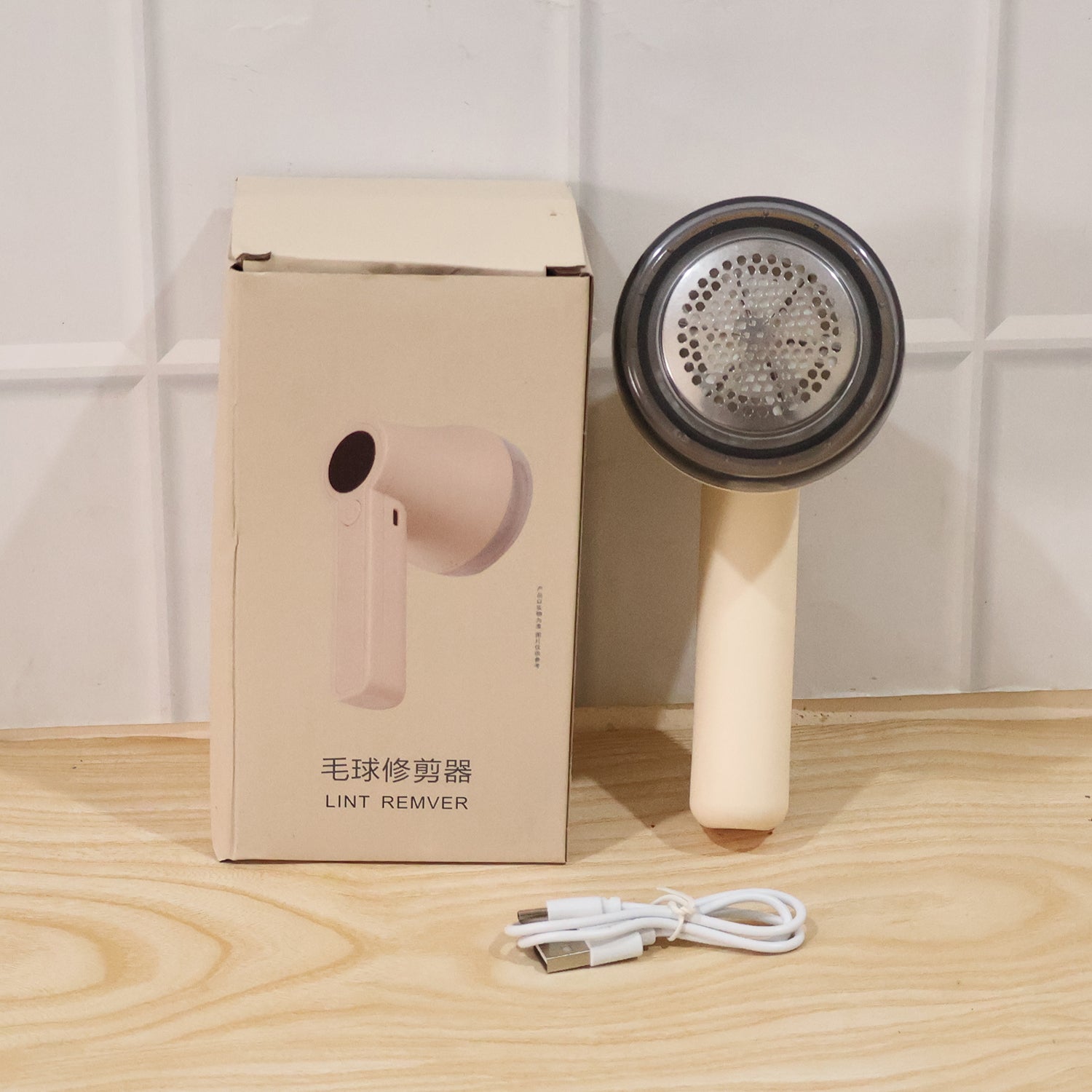 Wukusy rechargeable electric lint remover for clothes, sweaters, sofa, and blankets with a compact handheld design.