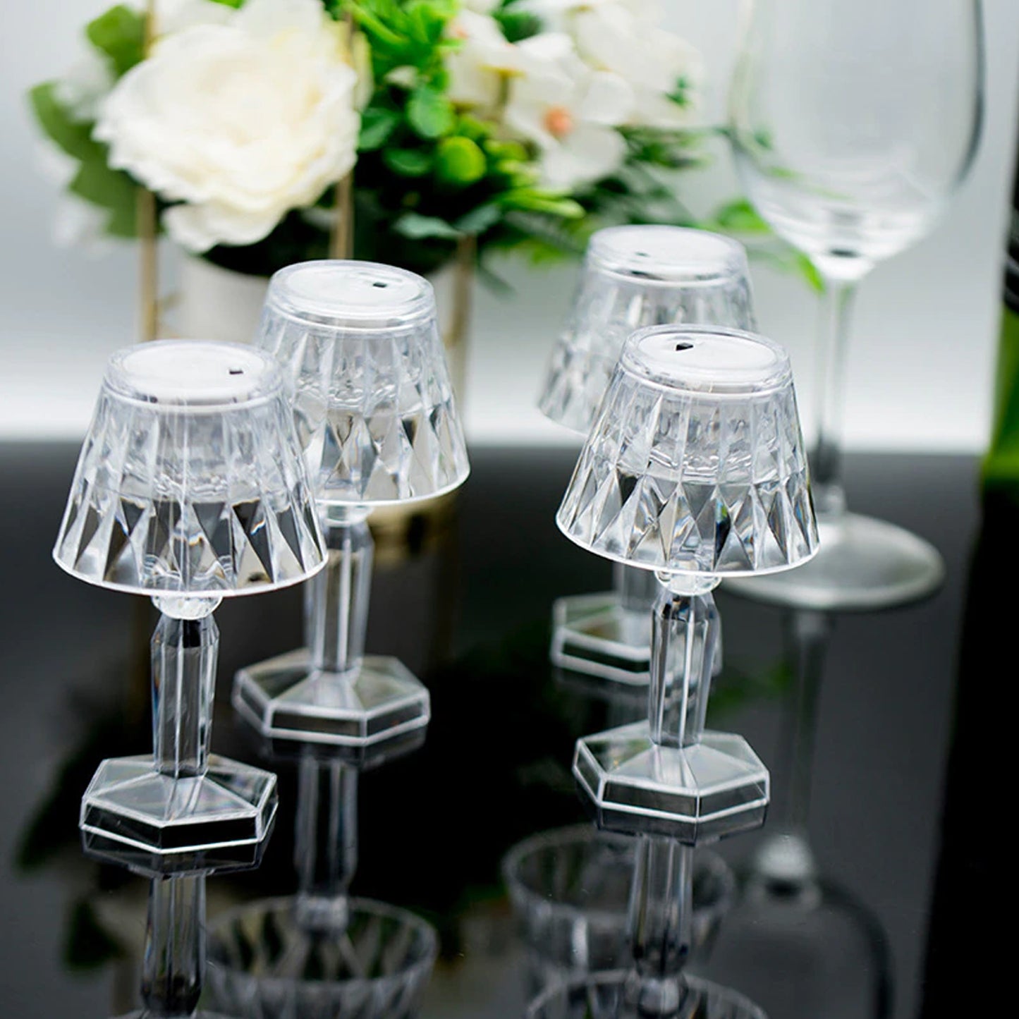 Wukusy 6610 2-in-1 transparent mini crystal table lamp with reflection light, showcasing its sleek design and glowing crystal details.