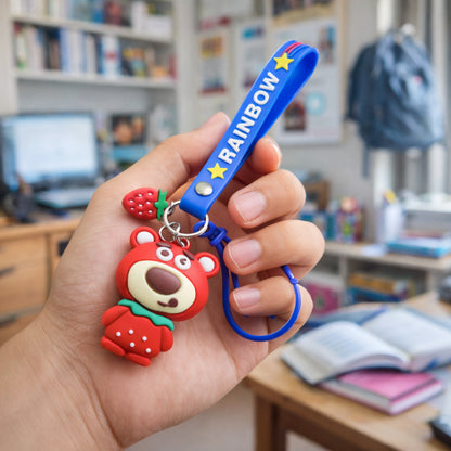 Wukusy cute teddy bear keychain with a colorful rainbow strap, small plush toy attached to a metal keyring.