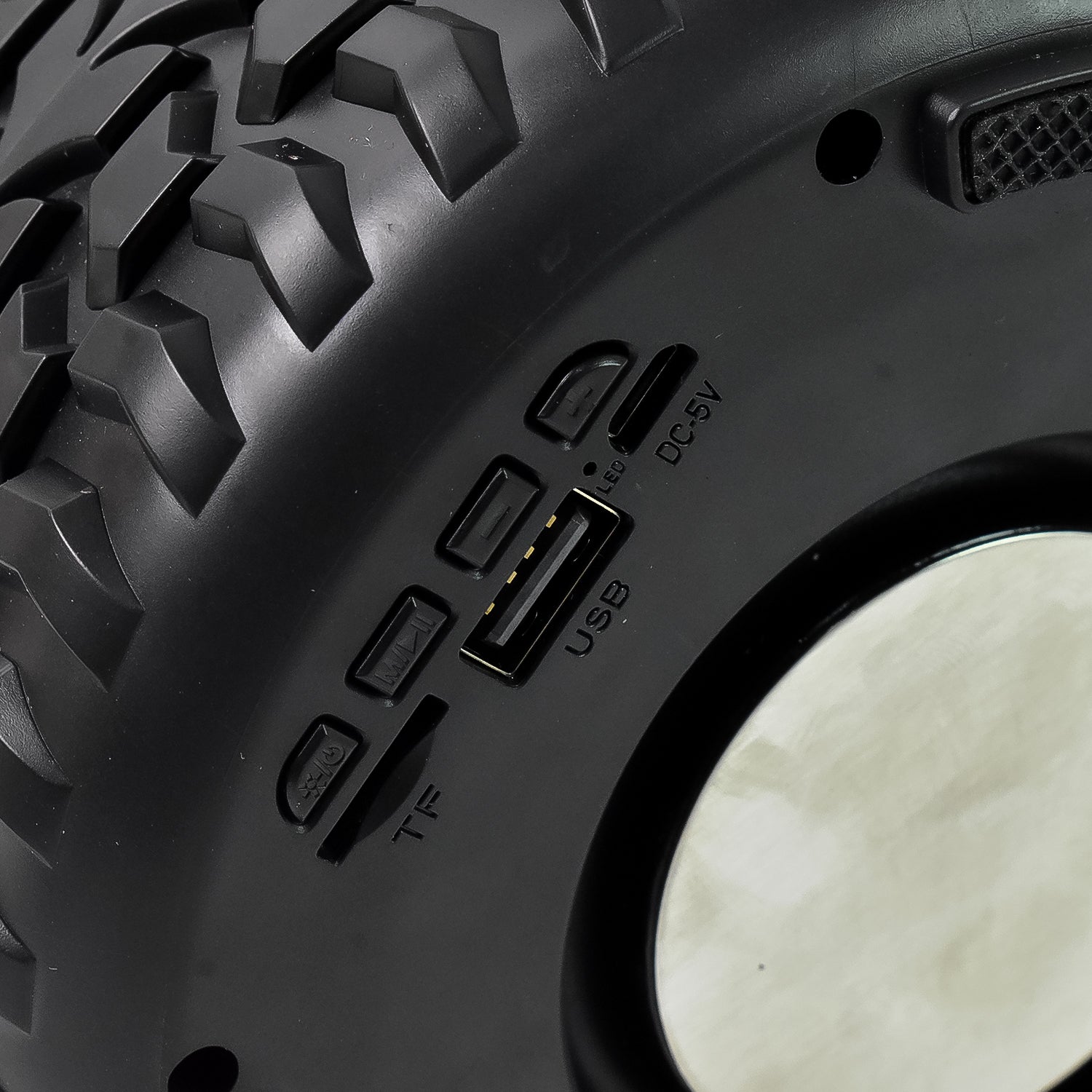 Wukusy portable wireless Bluetooth speaker shaped like a tyre wheel, compact mobile accessory with control buttons visible.