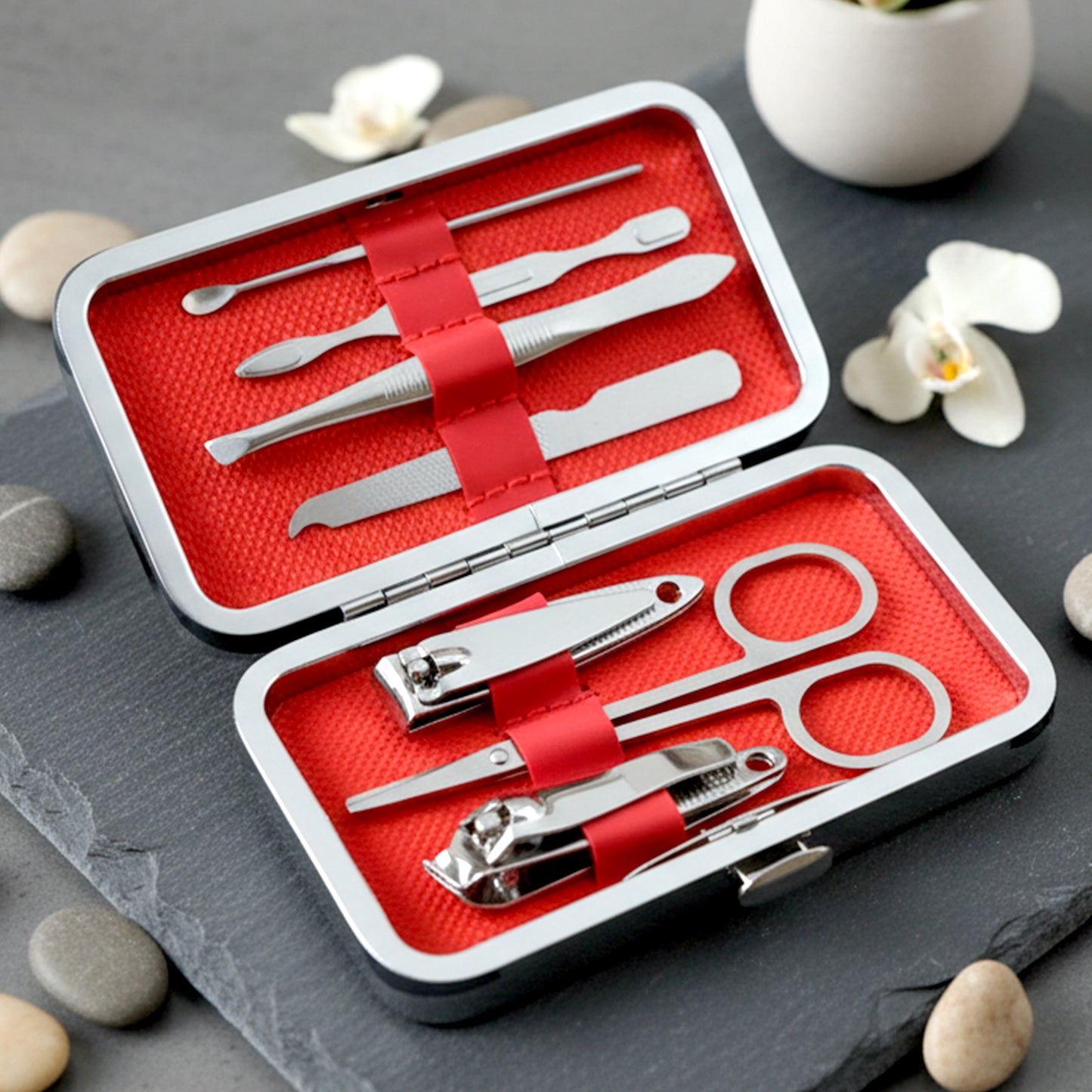 Wukusy 7-in-1 stainless steel manicure and pedicure grooming kit with various tools displayed on a white background.