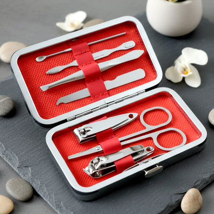 Wukusy 7-in-1 stainless steel manicure and pedicure grooming kit with various tools displayed on a white background.