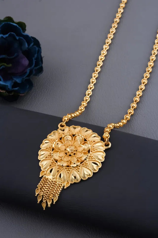 Gold plated women's Ki Mala mangalsutra with traditional design, featuring Moti Chen Ladi beads and a long, elegant pendant.