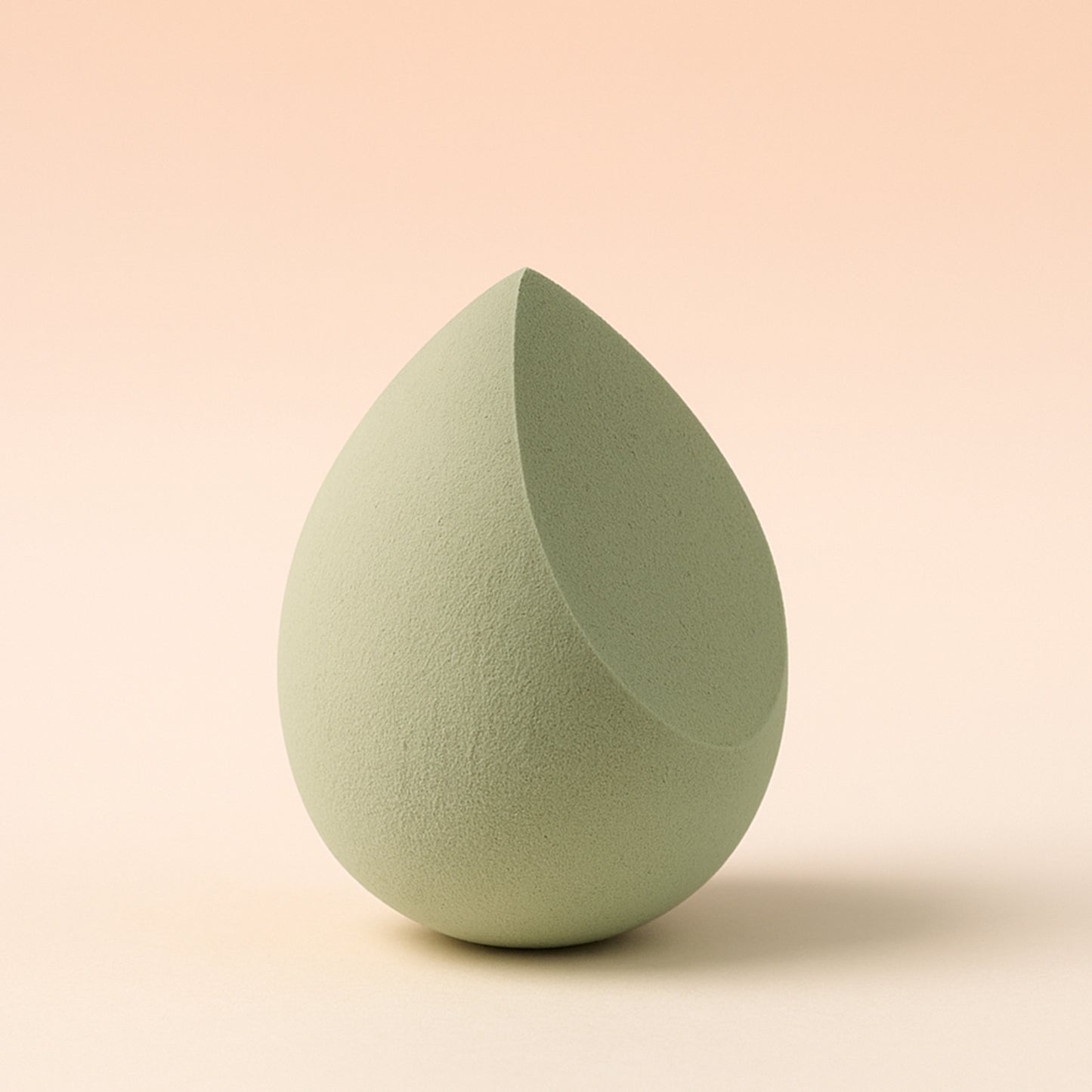 Multicolor Wukusy makeup sponge for blending liquid foundations, powders, and creams, shown in a close-up view.