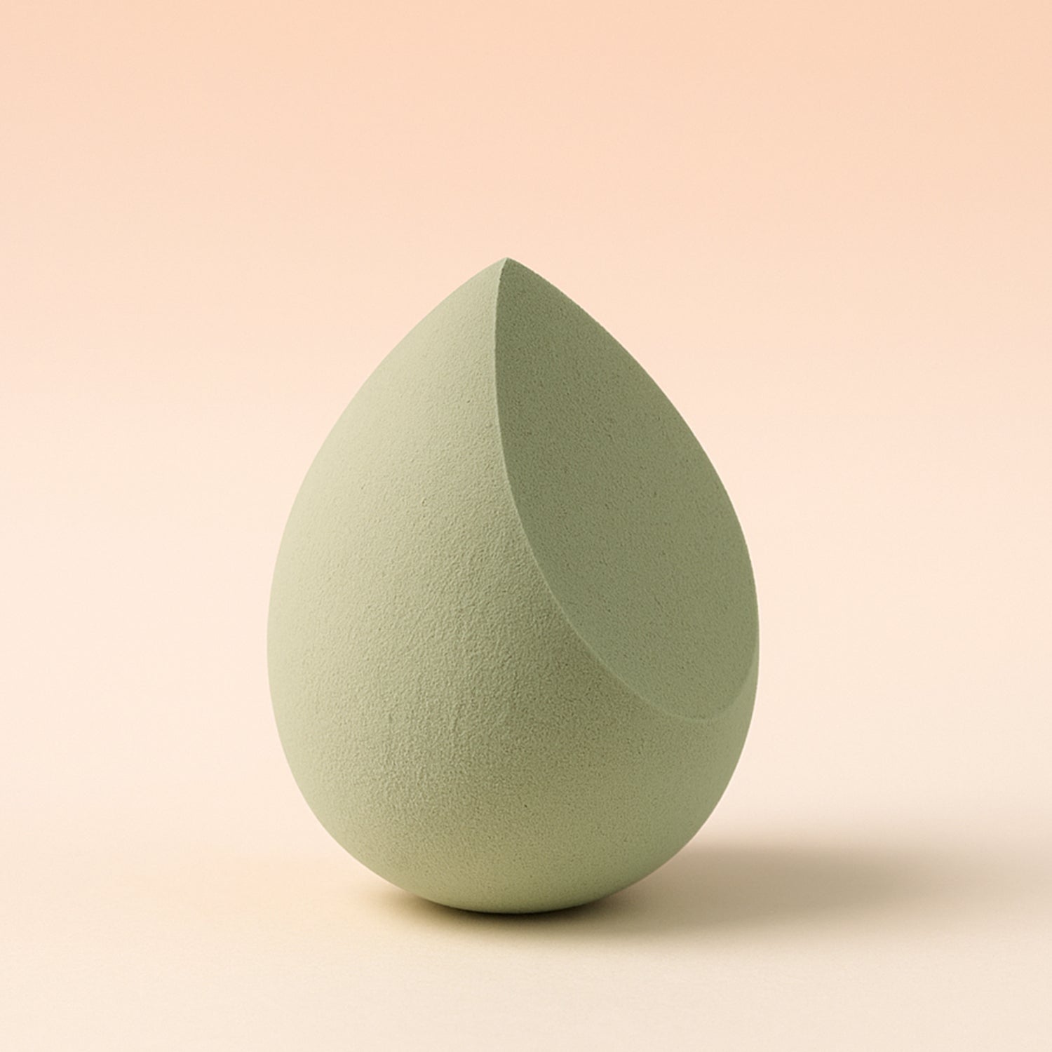 Multicolor Wukusy makeup sponge for blending liquid foundations, powders, and creams, shown in a close-up view.