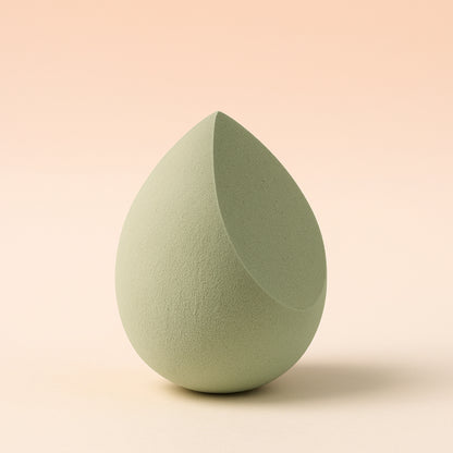 Multicolor Wukusy makeup sponge for blending liquid foundations, powders, and creams, shown in a close-up view.