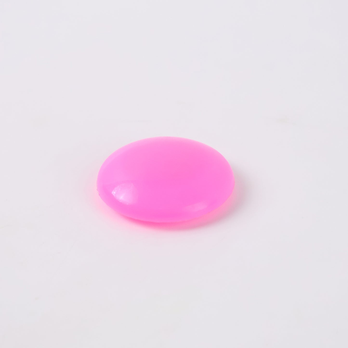Pink circular plastic magnets with Wukusy branding, ideal for office use, shown in this image.
