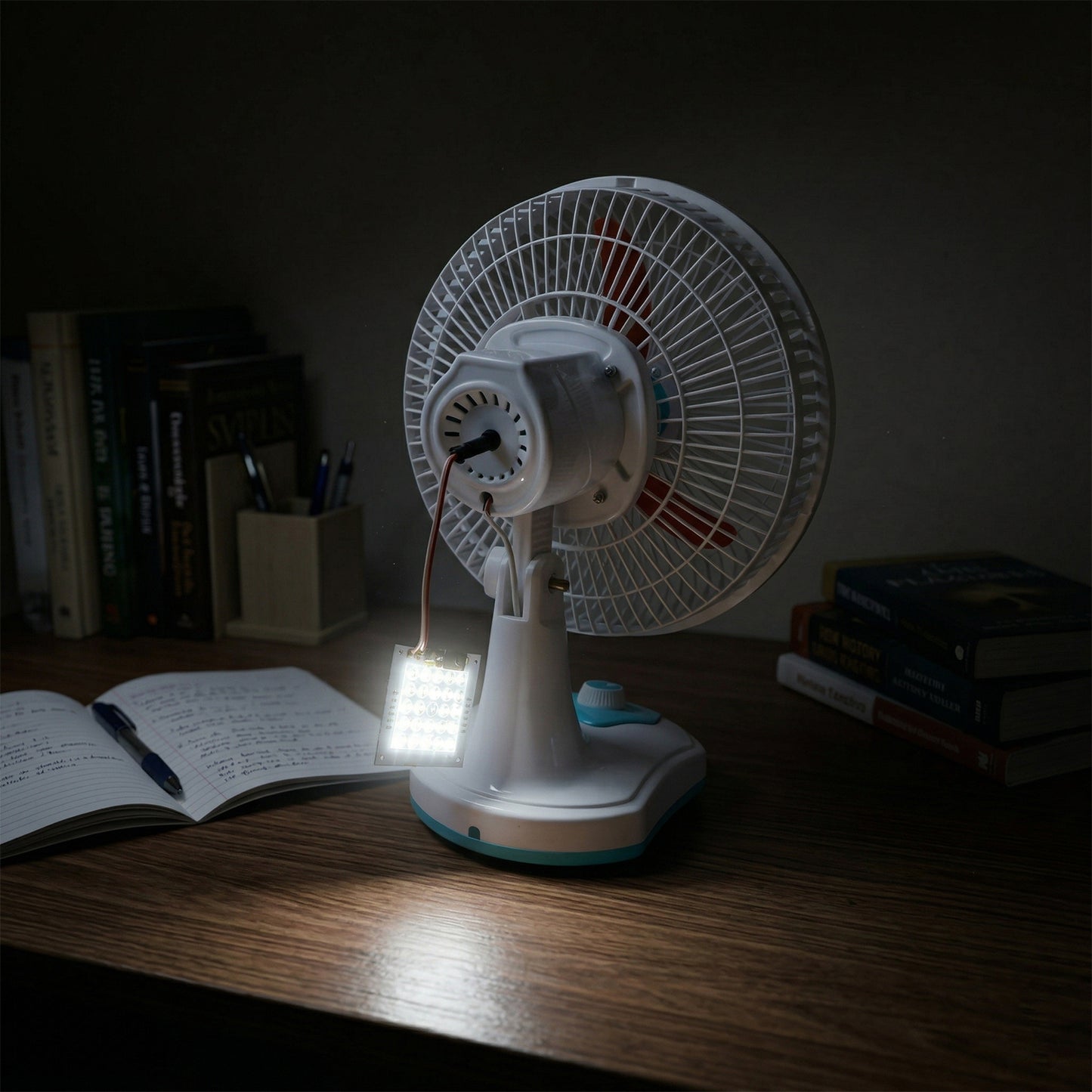 Wukusy Omega 12V rechargeable table fan with LED light, compact black fan on a white surface, powered by a 12-volt battery.