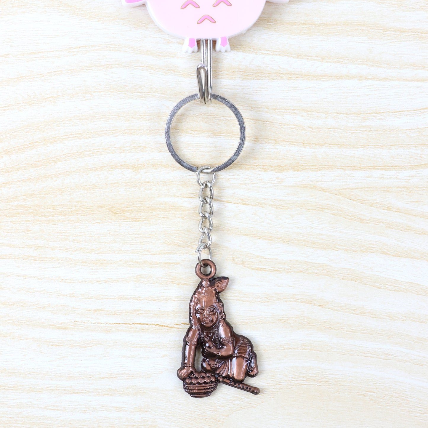 Wukusy Bal Krishna crawling design keychain with detailed colorful figure on a metal keyring.