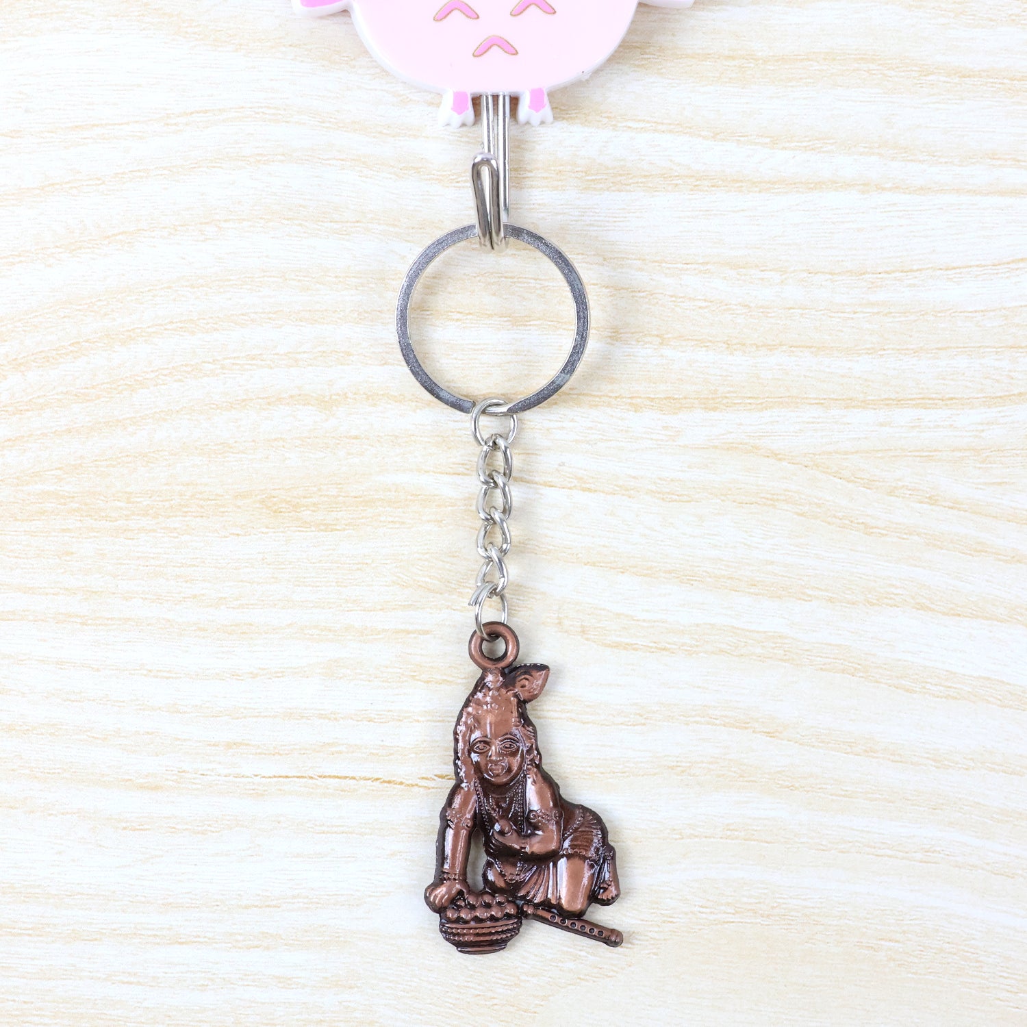 Wukusy Bal Krishna crawling design keychain with detailed colorful figure on a metal keyring.