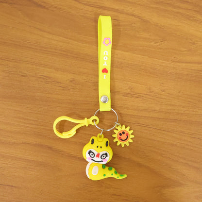 Wukusy cute cartoon dinosaur keychain with strap and decorative charm, featuring vibrant colors and playful design.