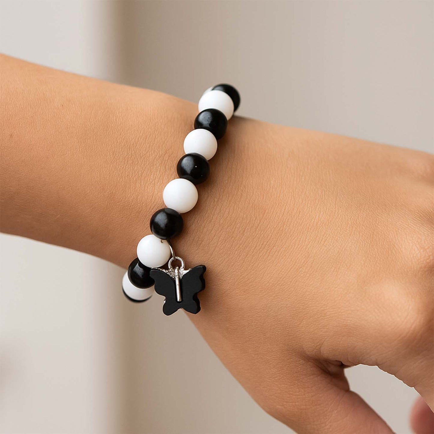 Elegant black and white fancy bracelet by Wukusy featuring intricate design and stylish accents, displayed on a neutral background.