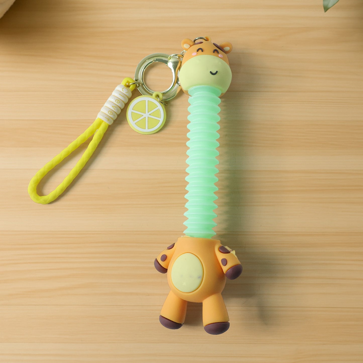 Wukusy cute giraffe cartoon keychain featuring a colorful giraffe design on a small metal keyring.