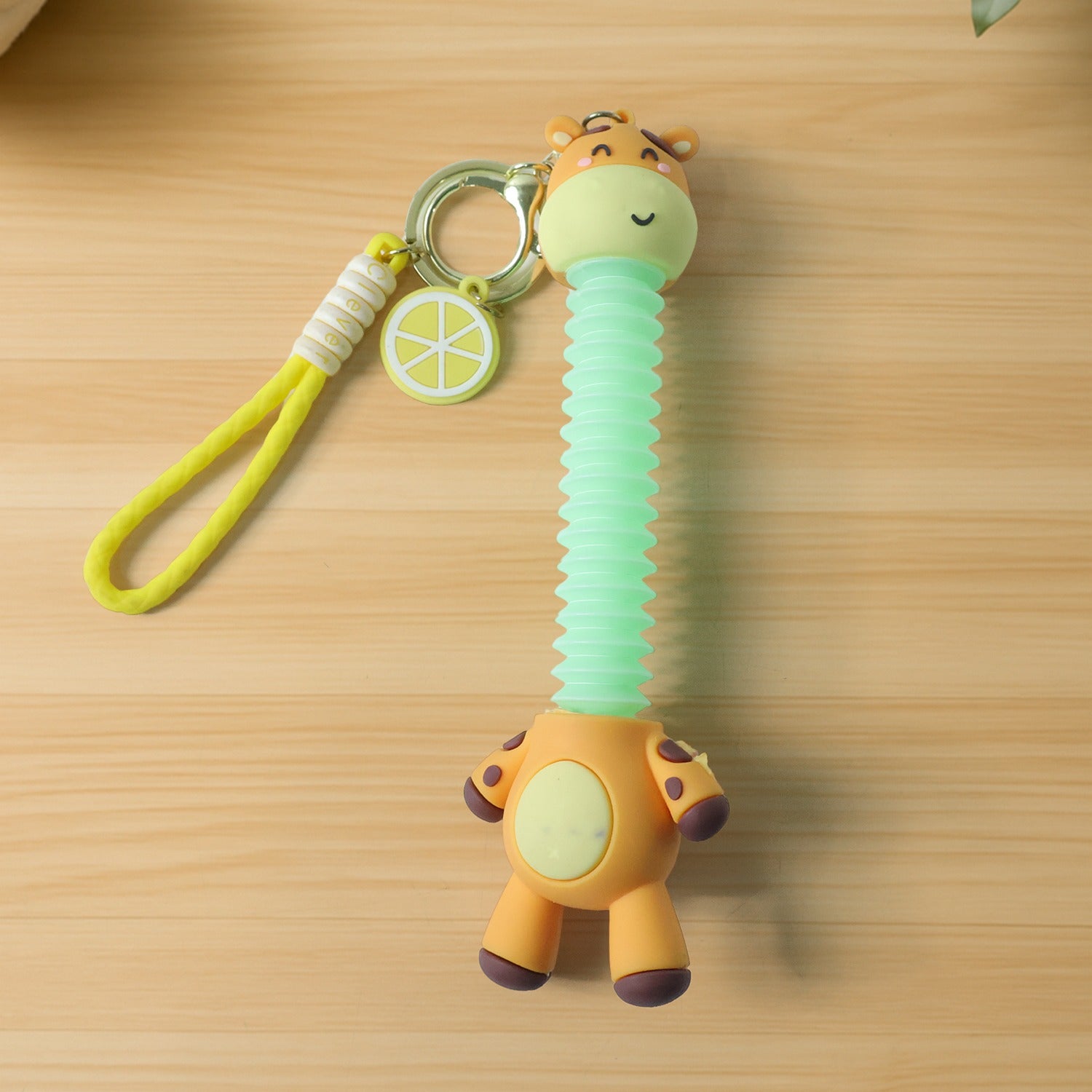 Wukusy cute giraffe cartoon keychain featuring a colorful giraffe design on a small metal keyring.