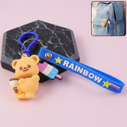 Cute bear cartoon keychain with rainbow strap from Wukusy, featuring a plush bear charm attached to a colorful rainbow strap.