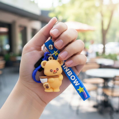 Cute bear cartoon keychain with rainbow strap by Wukusy, featuring a smiling bear design on a colorful strap.