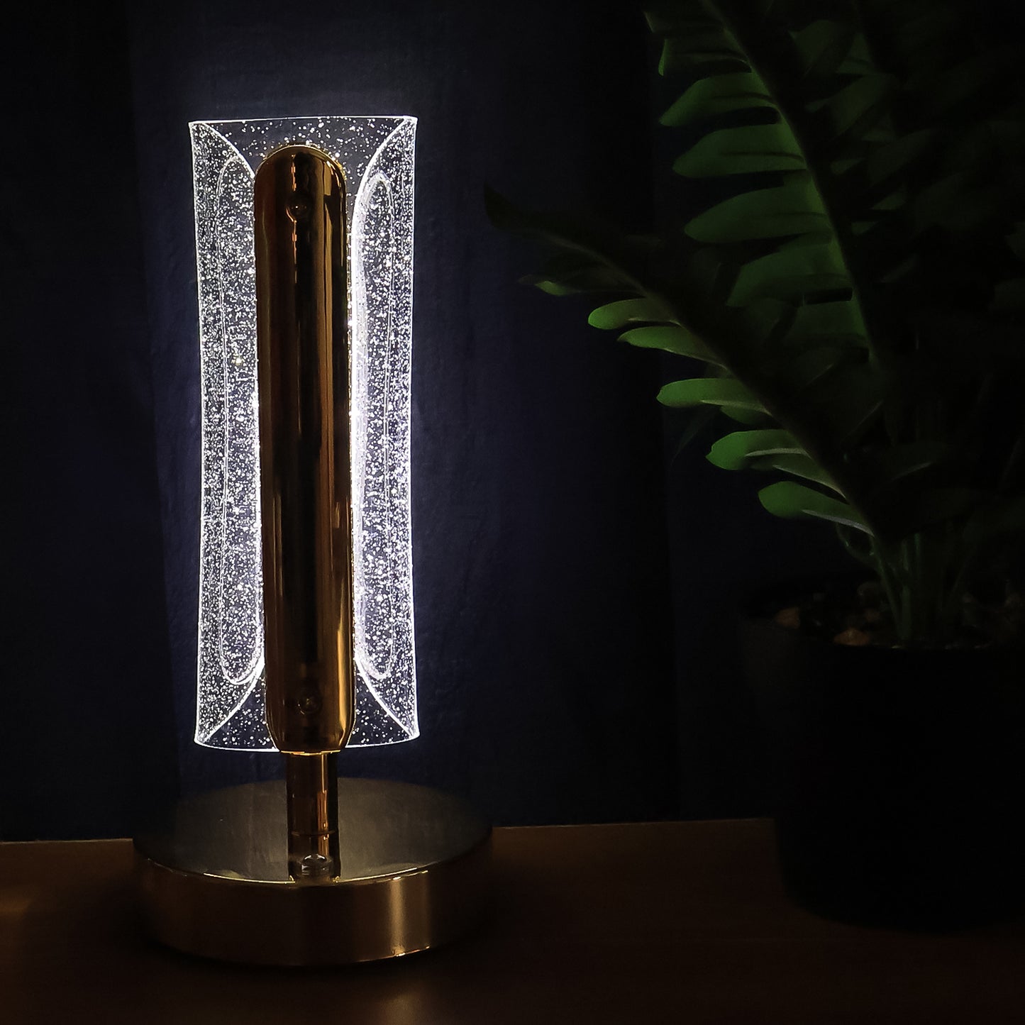 Elegant tall cylindrical crystal table lamp by Wukusy with a clear glass shade and metallic base, ideal for modern decor.