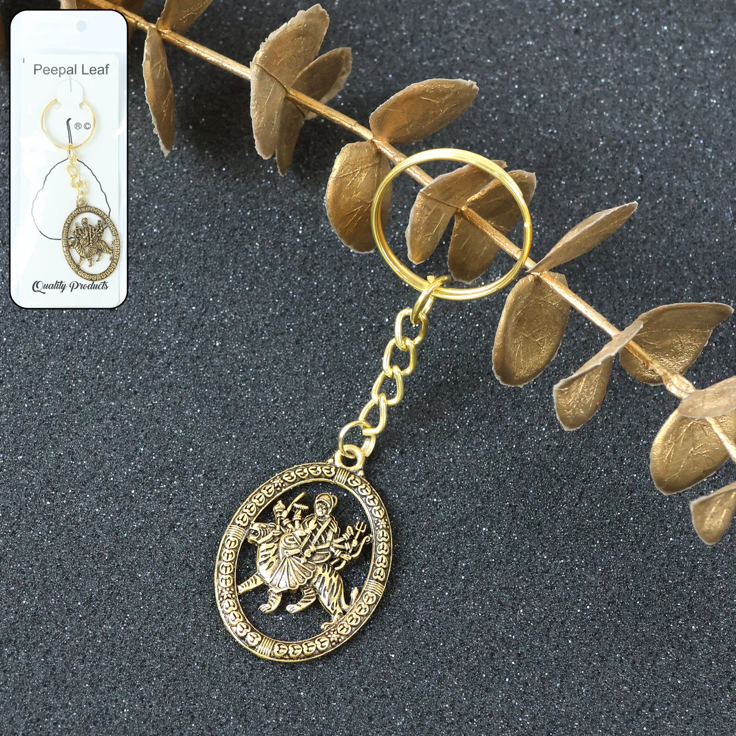 Golden Maa Durga oval frame keychain by Wukusy, featuring intricate religious design on a small, decorative keychain.
