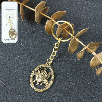 Golden Maa Durga oval frame keychain by Wukusy, featuring intricate religious design on a small, decorative keychain.