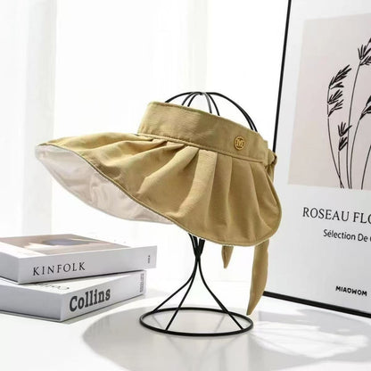 Wukusy women's wide brim sun visor cap with adjustable strap, summer accessory in random color, provides sun protection.