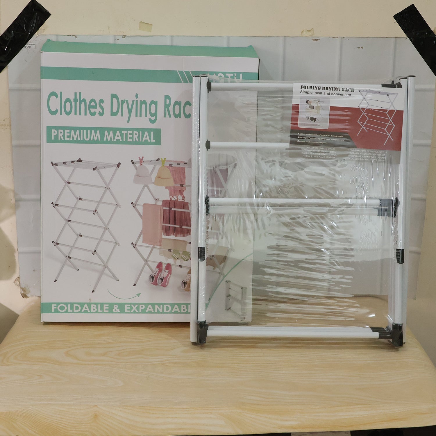 Wukusy metal foldable clothes drying rack with 3 tiers, portable laundry stand for air drying clothes and linens.