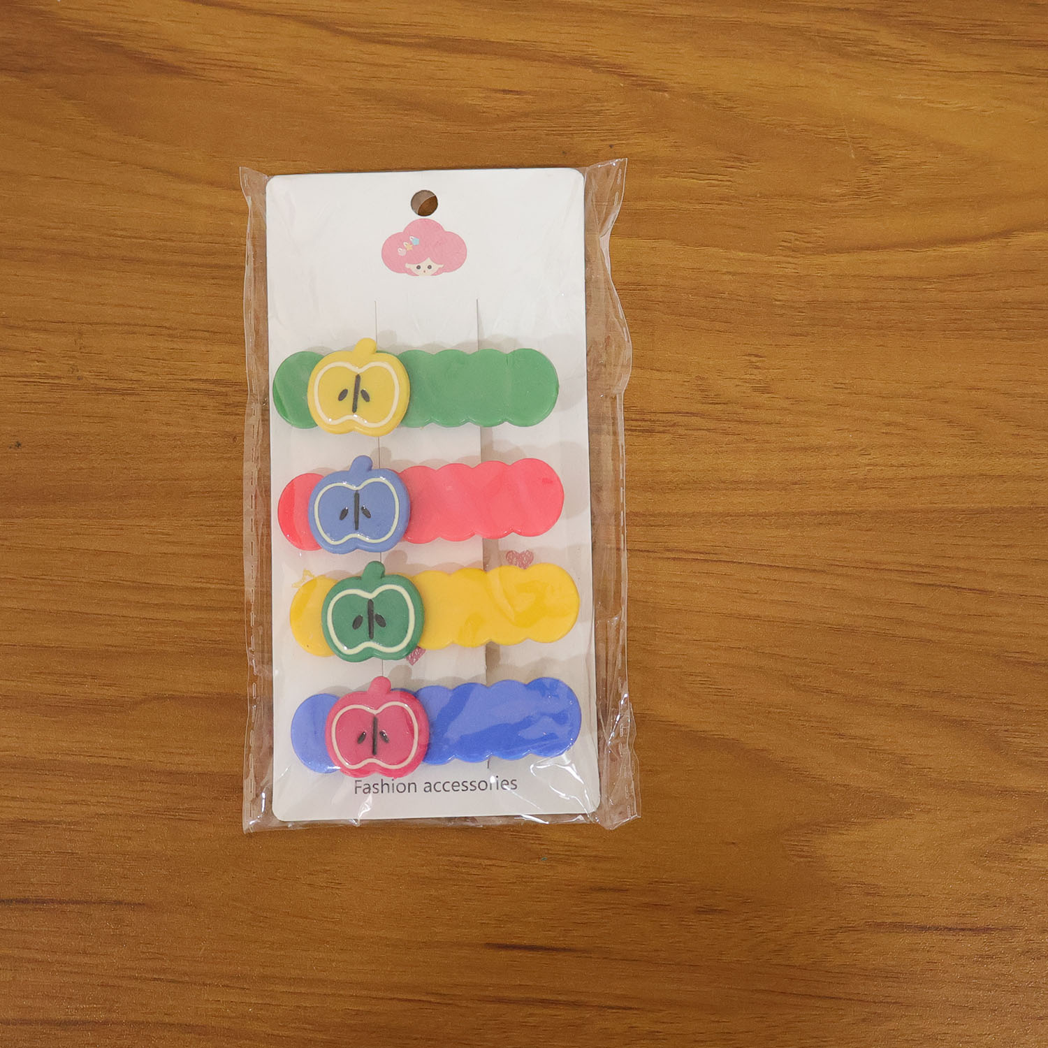 Set of four Wukusy apple-shaped hair clips featuring cute and colorful apple design for kids and women.