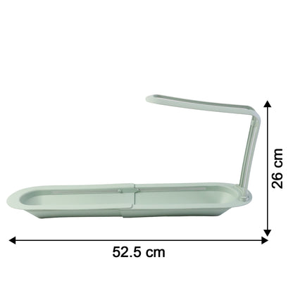 Plastic telescopic sink storage rack by Wukusy, extending to hold sponges and cleaning supplies near the kitchen sink.