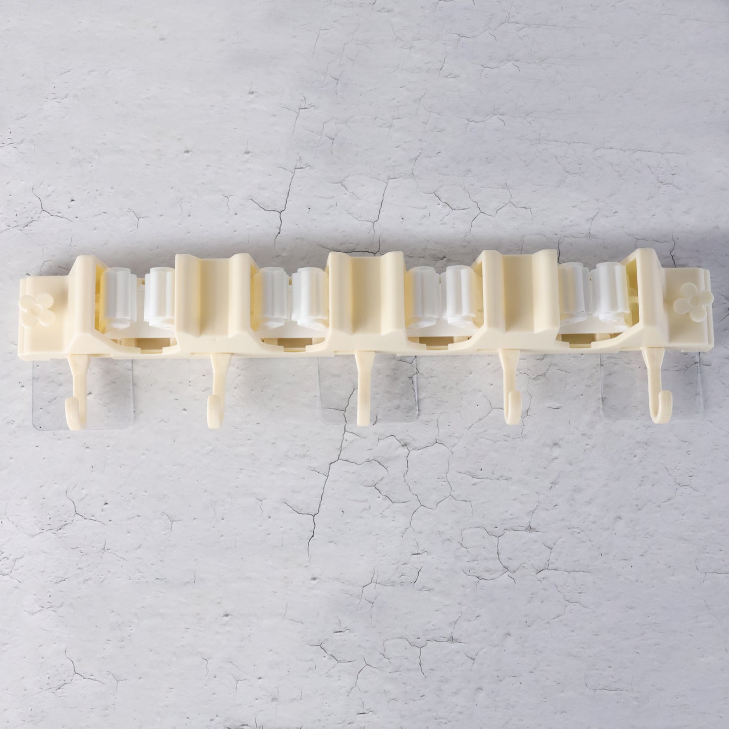 Wukusy self-adhesive wall-mount broom and mop holder rack mounted on wall for organized home cleaning tools.