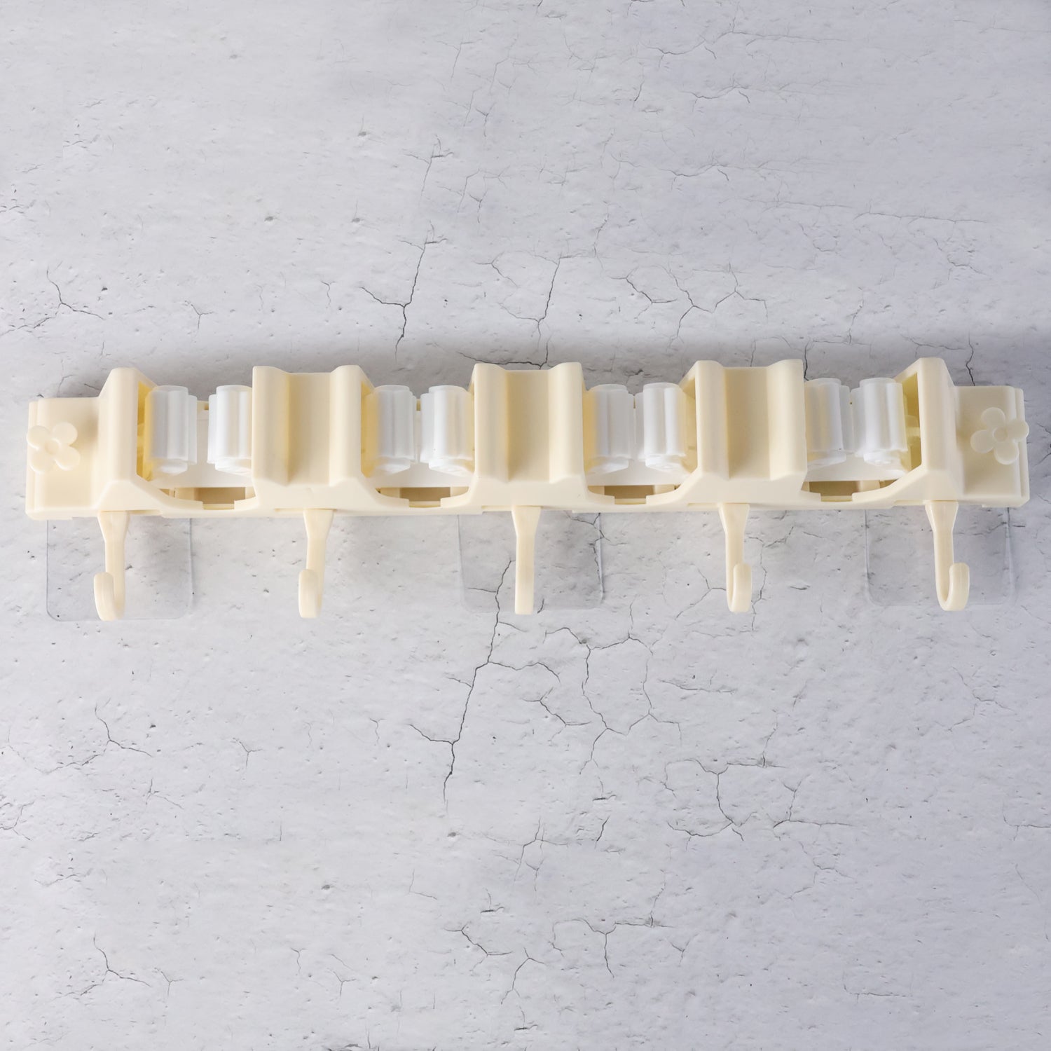 Wukusy self-adhesive wall-mount broom and mop holder rack mounted on wall for organized home cleaning tools.
