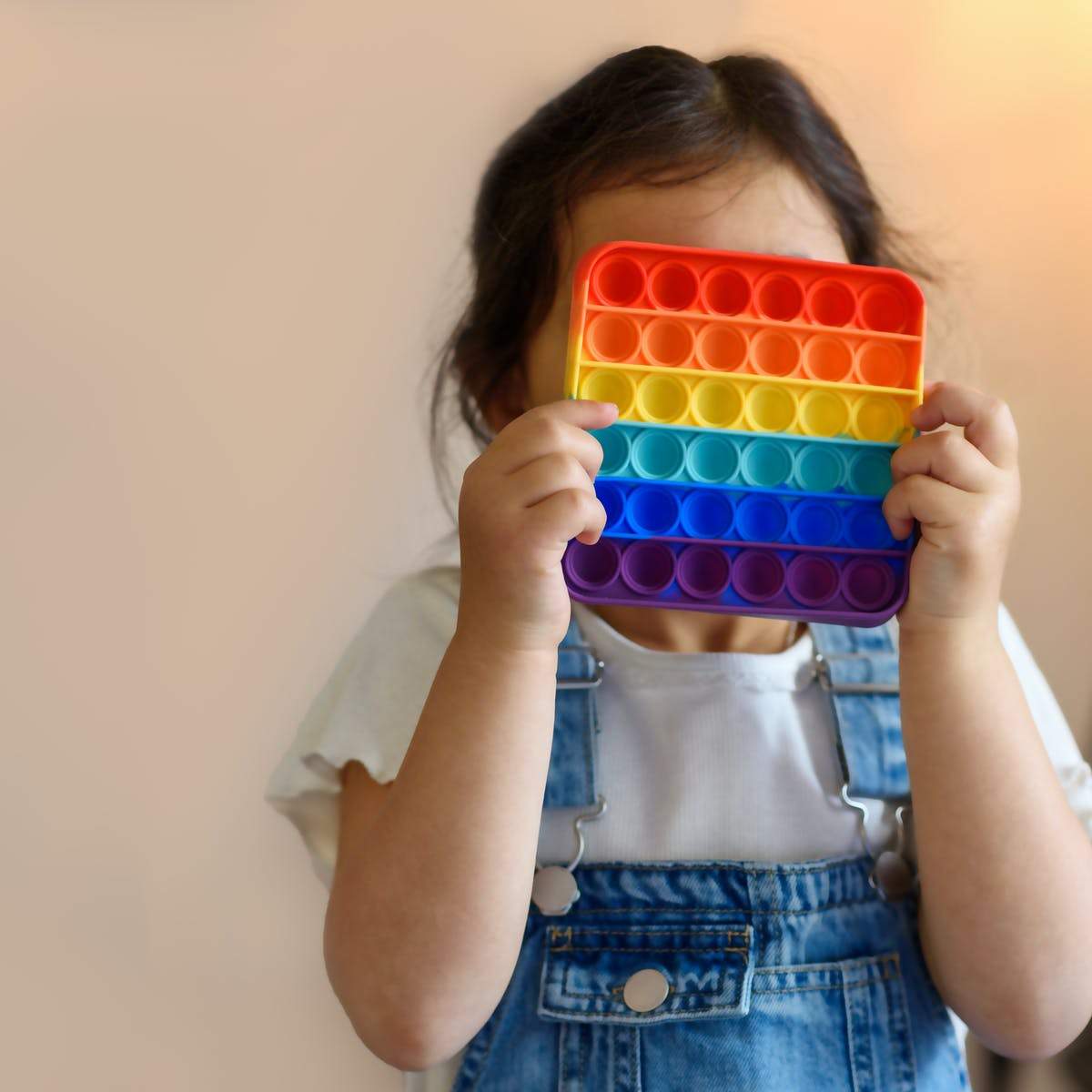 Wukusy rainbow-colored fidget toy with random shapes, made of soft silicone, designed for stress relief and sensory play.