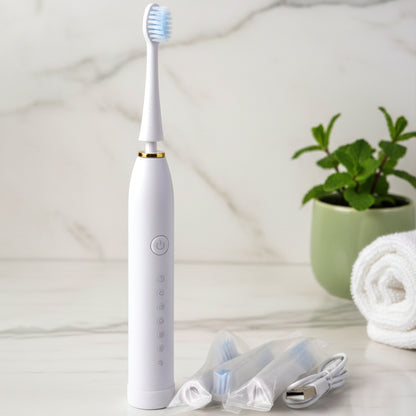 Wukusy rechargeable electric toothbrush in white with three extra brush heads on a clean background.