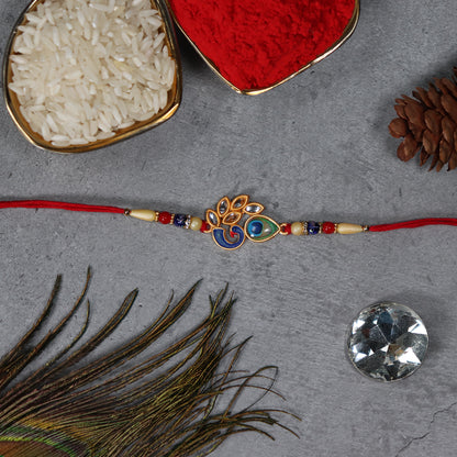 Colorful enamel and traditional thread on artistic Mor Pankh Rakhi by Wukusy, featuring vibrant design and intricate craftsmanship.