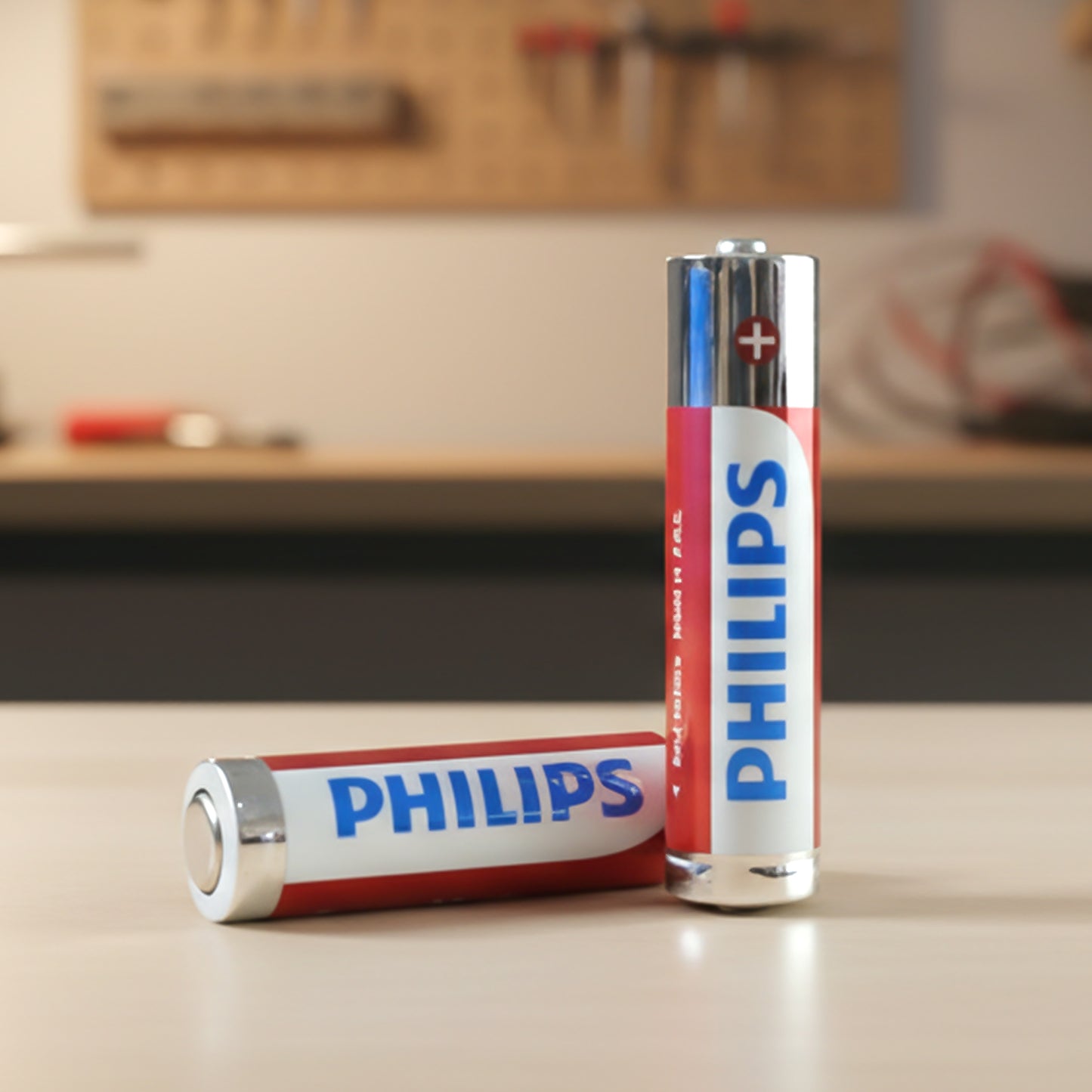 Wukusy AAA alkaline batteries in a 4-piece pack, showing the batteries with silver and black design and positive terminals visible.