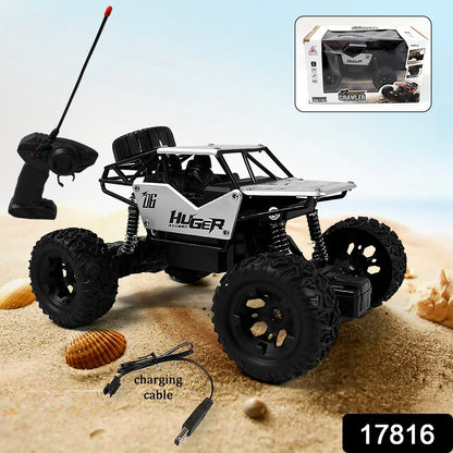 Wukusy 1:18 scale rock crawler monster RC truck performing stunts on outdoor terrain, rechargeable all-terrain toy car for kids